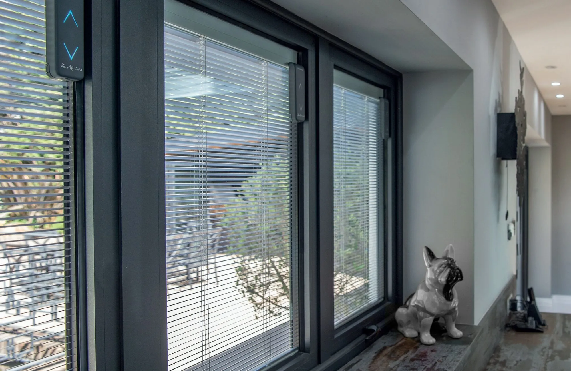 Sliding glass doors with blinds a dog figurine in the foreground