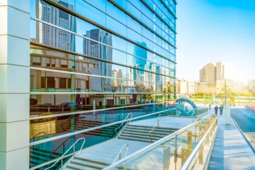 A modern commercial building featuring glass walls and aluminum glass railings complemented by stylish stairs