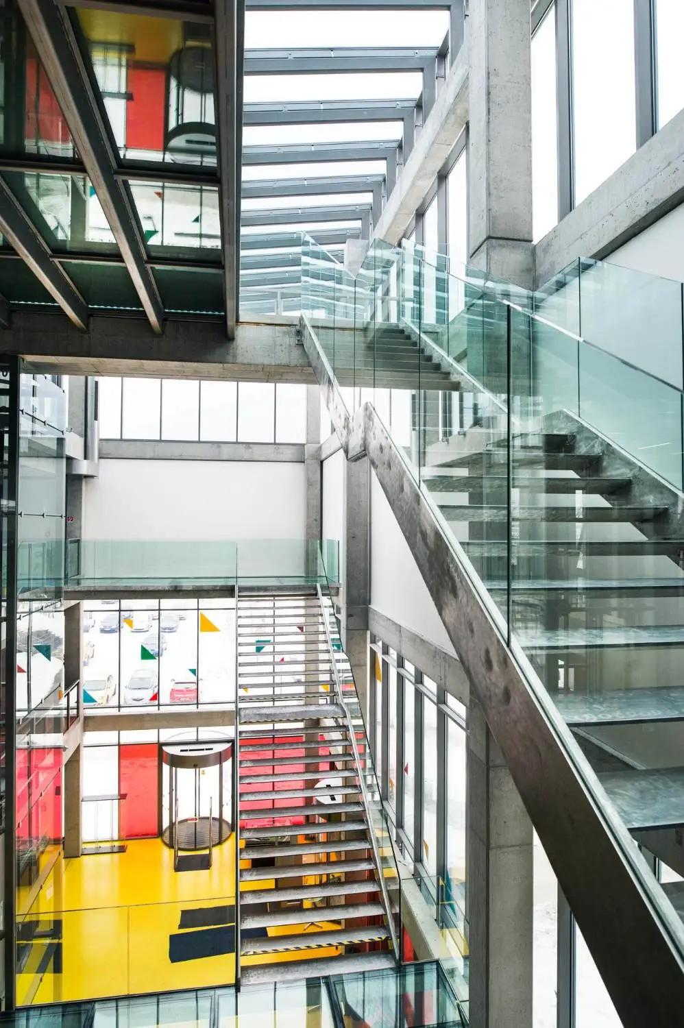 A modern stairway featuring glass walls and U Channel glass railing showcasing a sleek and contemporary design