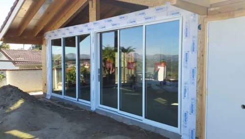 Framed aluminum sliding doors during exterior construction