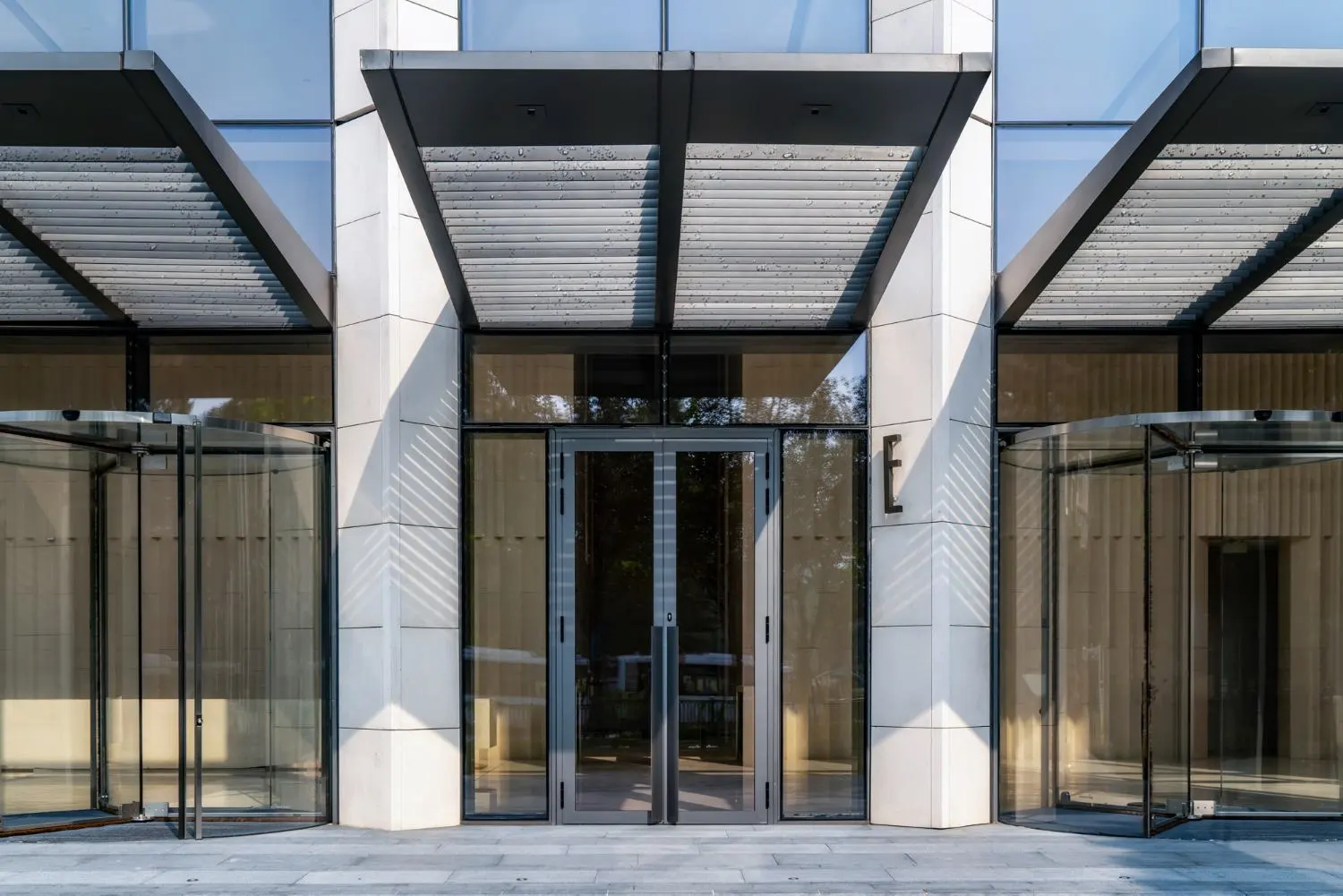 Modern entrance featuring glass doors and awning for commercial projects