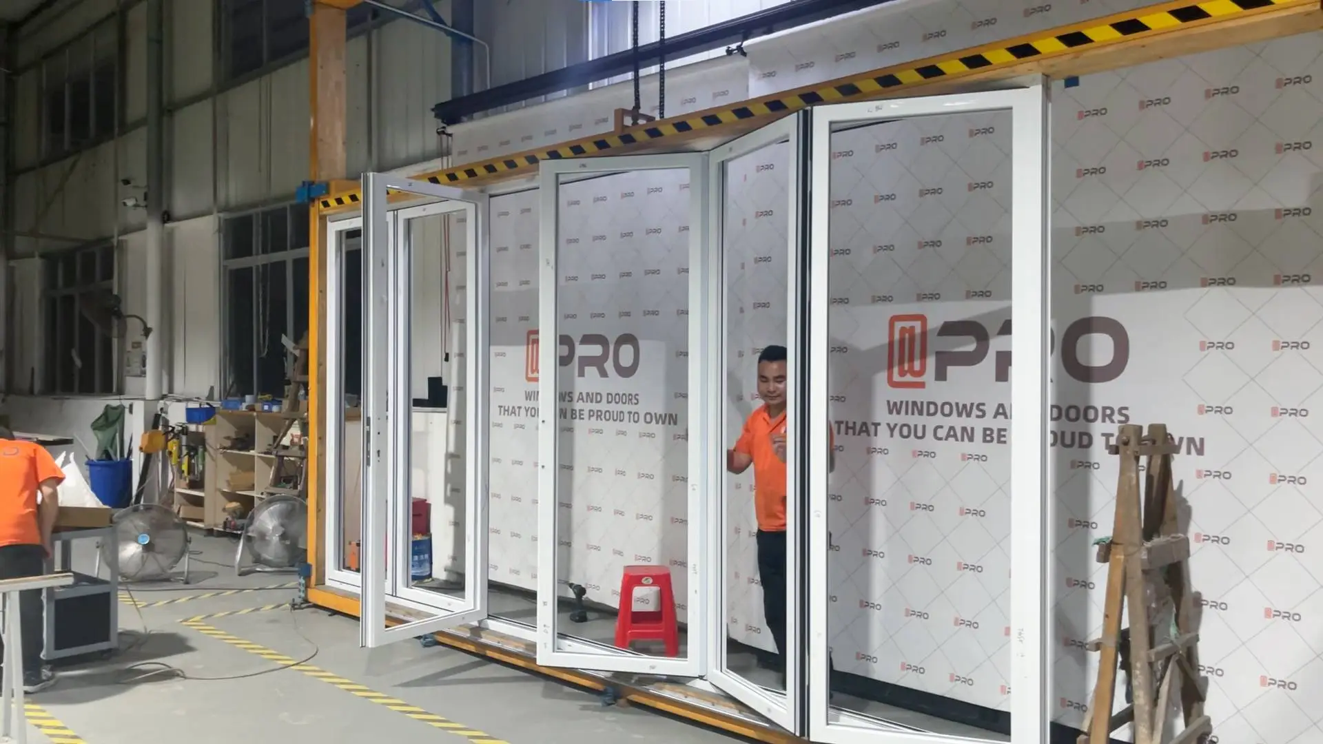 Technician adjusting sliding glass door in a workshop