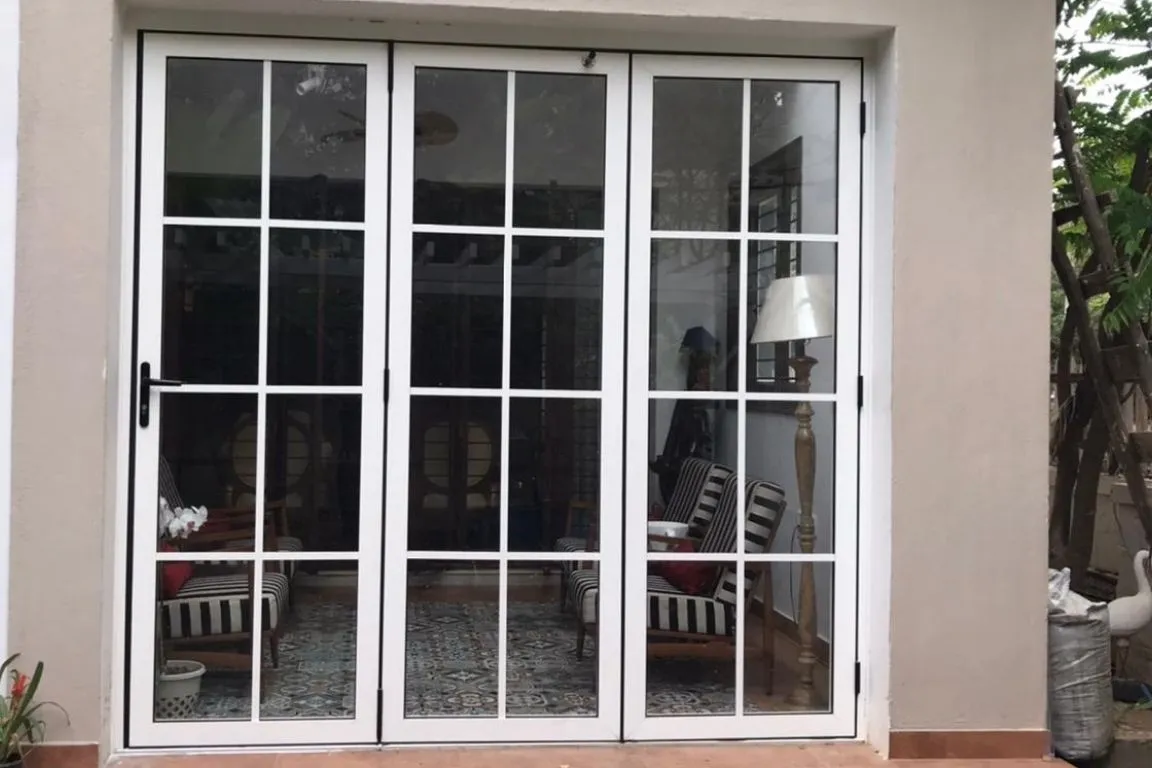 White aluminum French doors leading to an indoor patio area