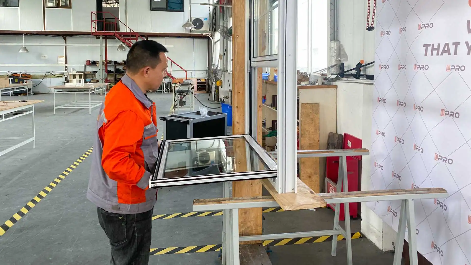 Worker assembling a sliding glass door frame