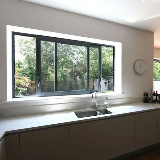 Aluminum kitchen window overlooking garden area outside