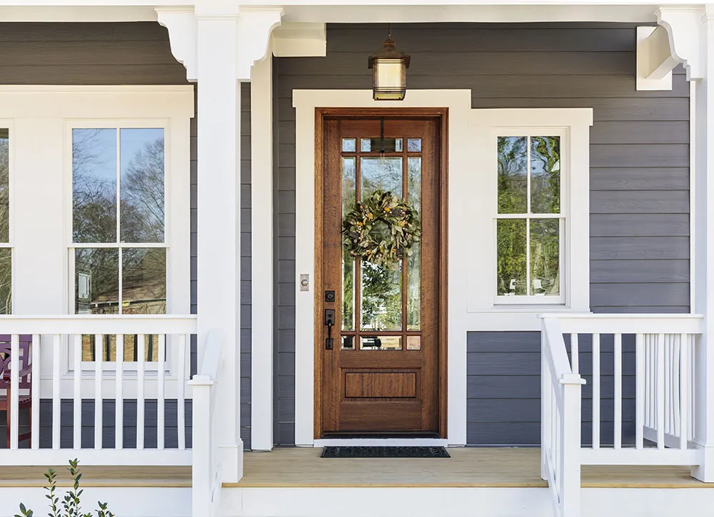 Classic farmhouse style wooden front door with wreath