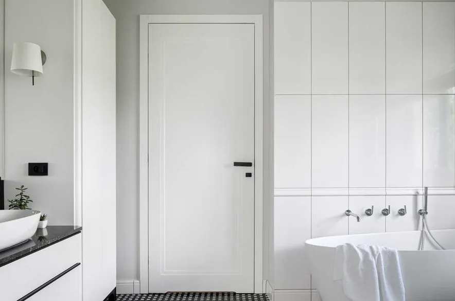 Minimalist white door in a contemporary bathroom