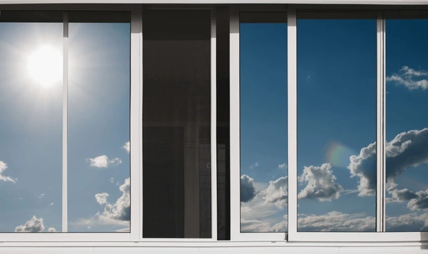 Reflective aluminum sliding windows with blue sky and clouds