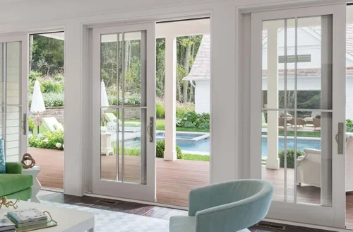 Sliding glass doors opening to a poolside view in a living room