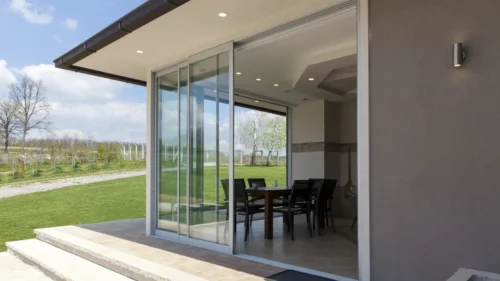 Sliding glass patio door opening to a sunny lawn