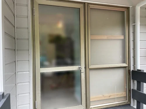 Frosted glass and aluminum door setup with an exterior view