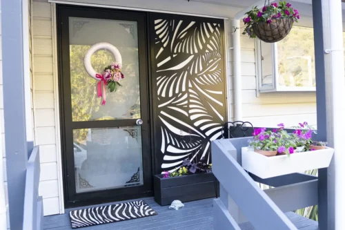 Modern front door with decorative floral design and wreath