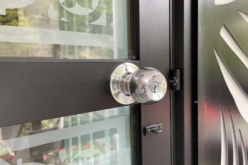 Polished aluminum door with decorative glass and a chrome knob