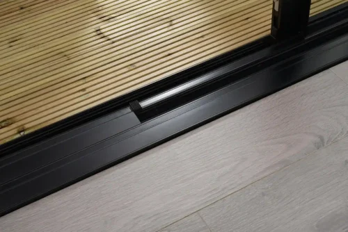 Close up of bifold door threshold with decking and flooring