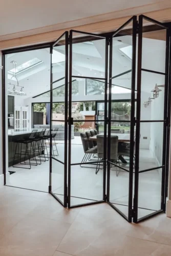 Sleek aluminum bifold doors opening into a spacious patio area