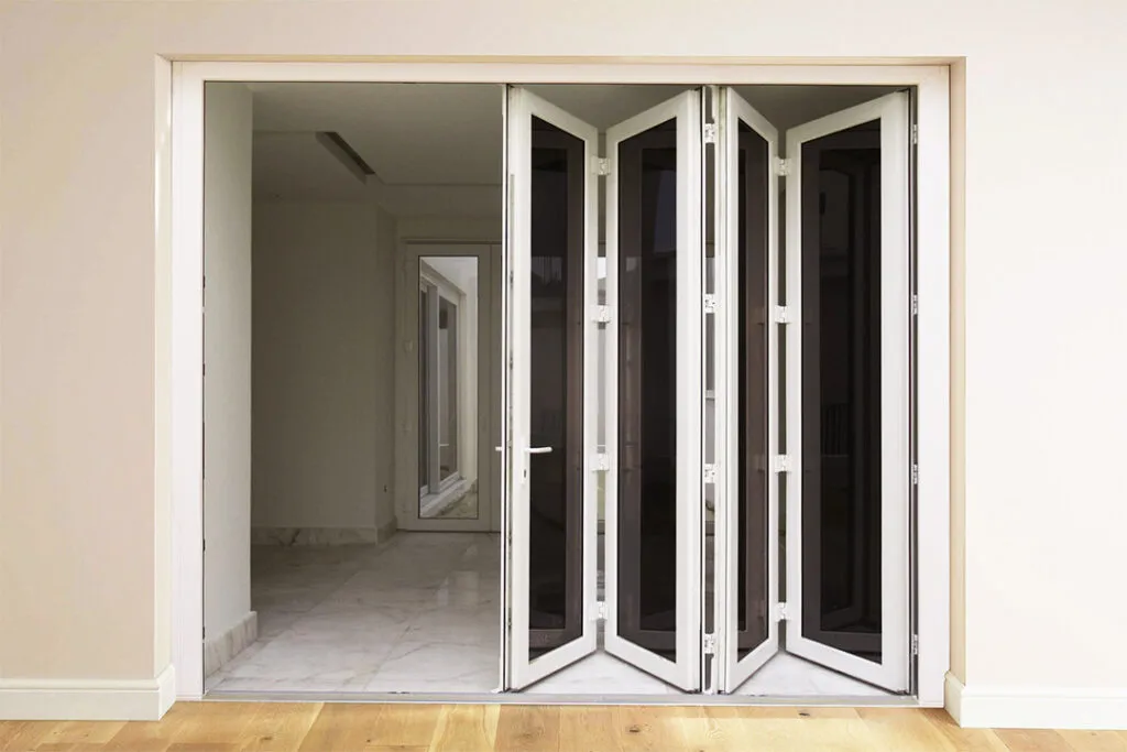 White uPVC folding doors with glass panels in a modern interior space