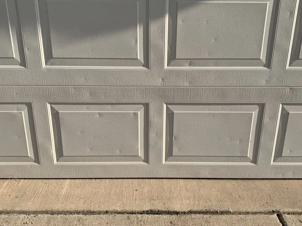 A dented section of a garage door panel