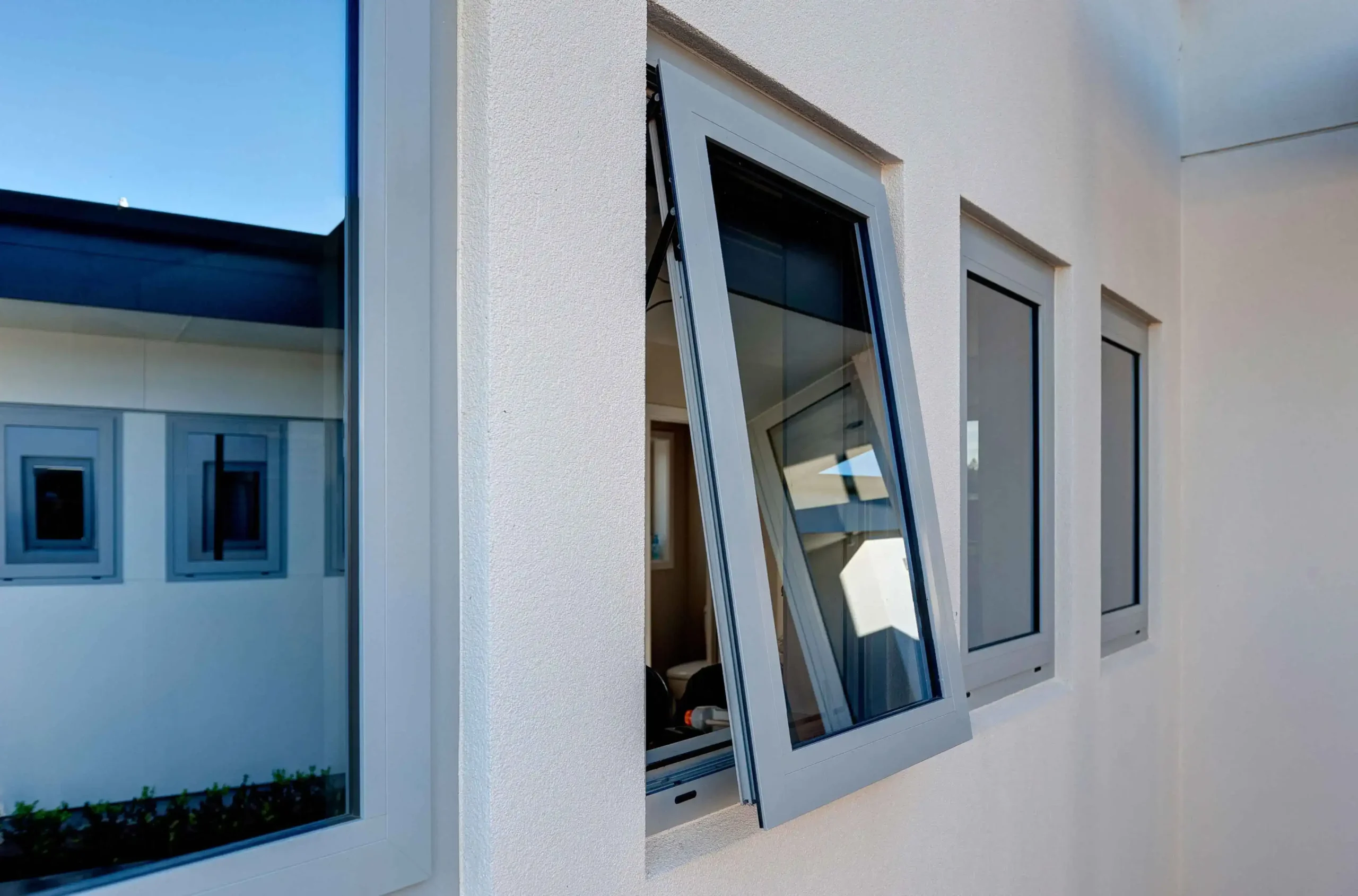 Row of open awning windows with a sleek white frame