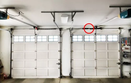 Two garage doors with windows and overhead door mechanism