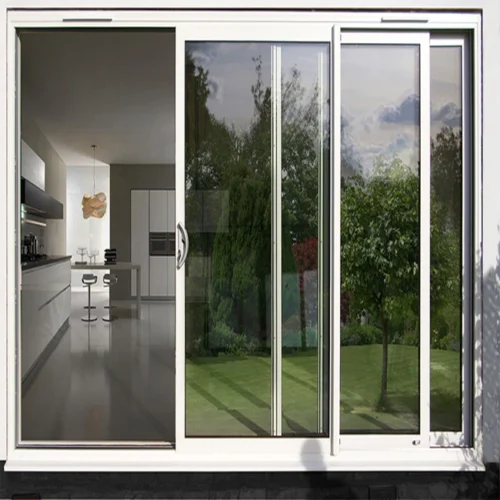 White aluminum sliding door opening to a garden and kitchen