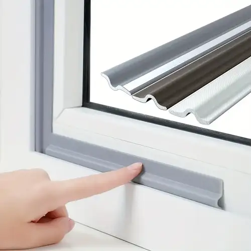 A finger touching window trim with different materials