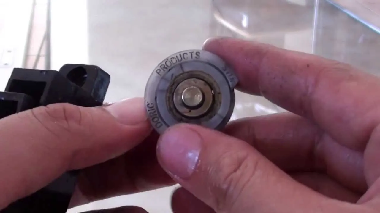 Close up of hands adjusting a sliding glass door roller